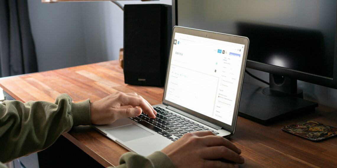 person typing on laptop