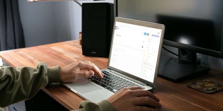 person typing on laptop