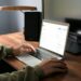 person typing on laptop