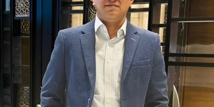 man in a blue coat wearing glasses
