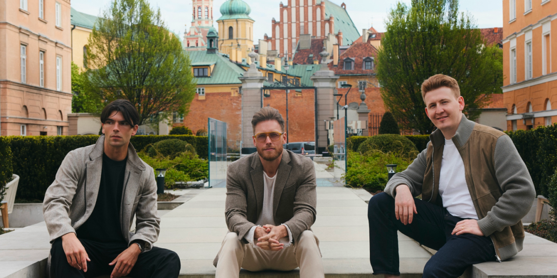three men posing outdoors