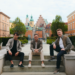 three men posing outdoors