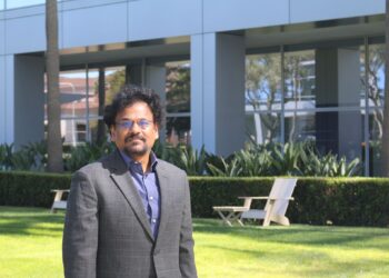 man wearing glasses posing outdoors