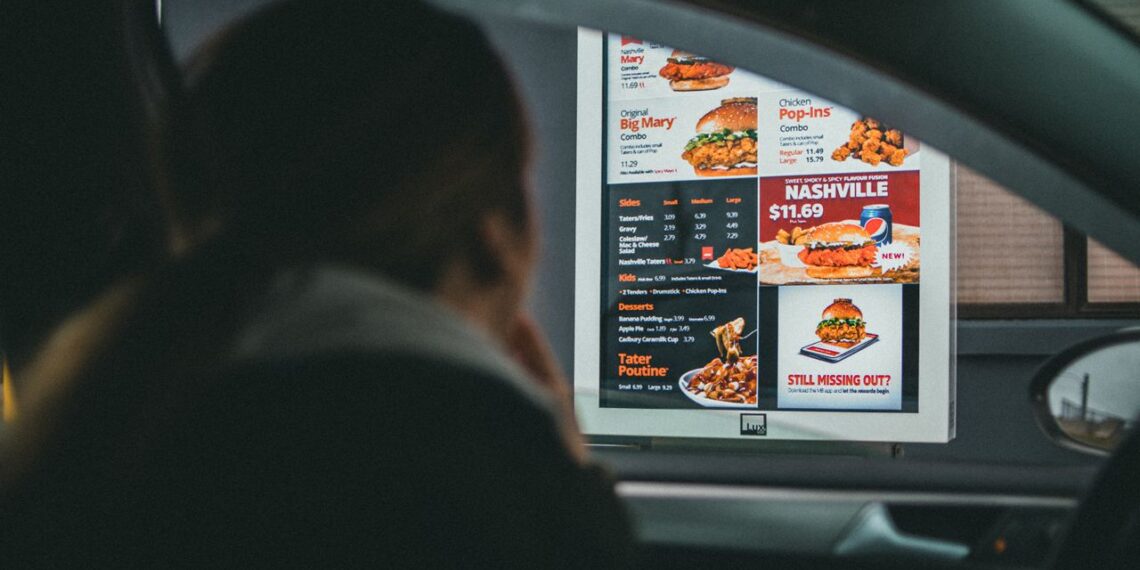 man ordering at a drive thru